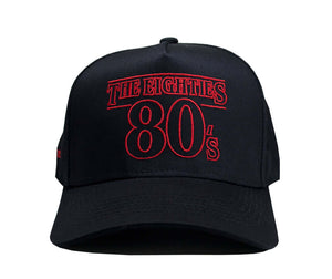 80s Retro Snapback in black with red embroidery, featuring 'The Eighties' and '80's' text design.